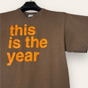 “This is the year” Orange Graphic Brown Tee
Tagged L